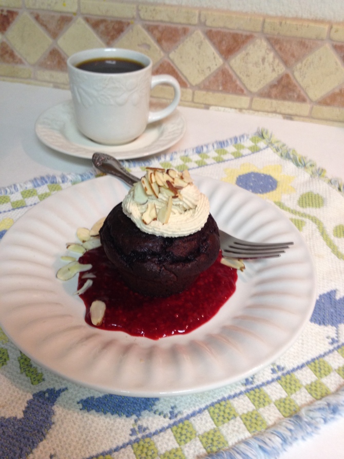 Double Chocolate Cupcakes over Raspberry Sauce Topped with Almond Mocha Whipped Cream with Coffee