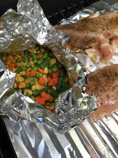 foil tented vegetables on a barbecue