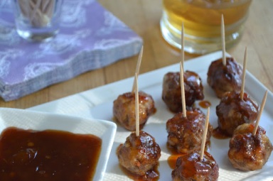Bourbon Meatballs on a small white plate with dipping sauce